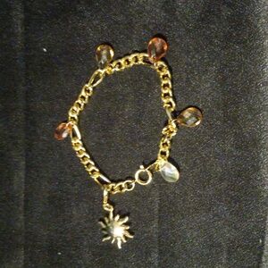 Vintage Figaro chain bracelet with Crystal charms and sun charm. 7"